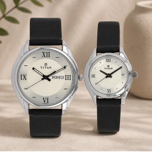 Two Titan wristwatches with black straps on a beige surface; the larger left watch shows the day and date window with Roman numerals I–VI and XII, while the right watch has a simple dial with Roman numerals.