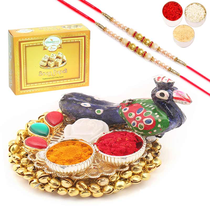 Peacock Gungroo Roli Chawal Container with 2 Pearl Rakhis With Soan Papdi